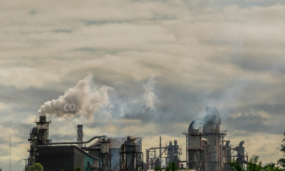 A factory spews out CO2 smoke from its chimneys
